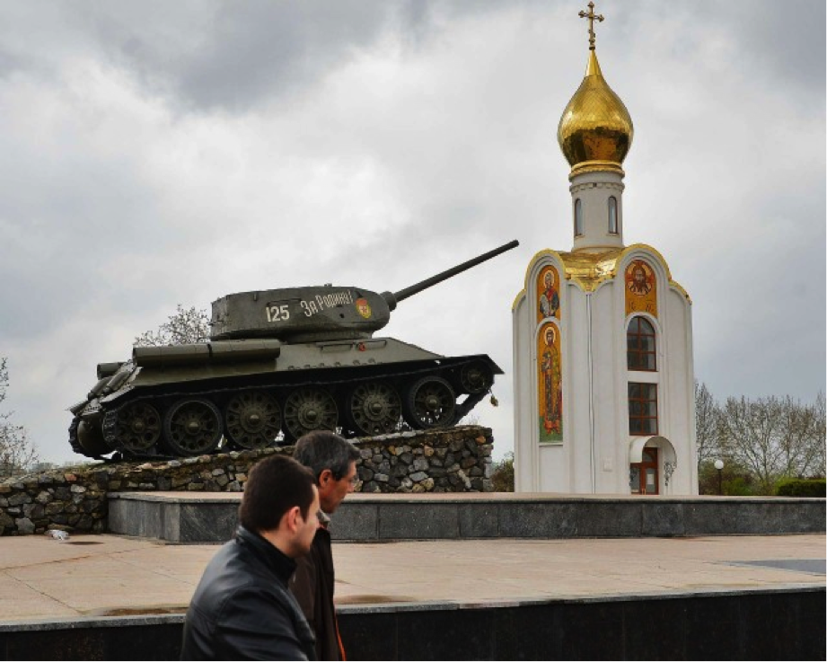 People walk past a monument celebrating the Soviet victory over the German army in Tiraspol, Moldova, in April 2014. (DANIEL MIHAILESCU/AFP/Getty Images)