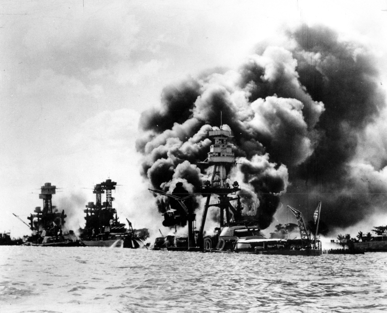 Three U.S. battleships are hit from the air during the Japanese attack on Pearl Harbor on Dec. 7, 1941. Japan's bombing of U.S. military bases at Pearl Harbor brings the U.S. into World War II. From left are: USS West Virginia, severely damaged; USS Tennessee, damaged; and USS Arizona, sunk. (AP Photo)