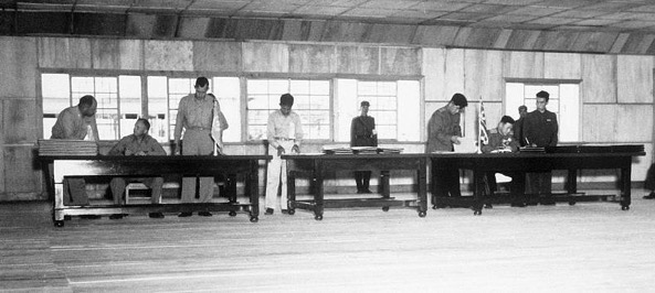 UN delegate Lt. Gen. William K. Harrison, Jr. (seated left), and Korean People’s Army and Chinese People’s Volunteers delegate Gen. Nam Il (seated right) signing the Korean War armistice agreement at Panmunjom, Korea, July 27, 1953. (Department of Defense)