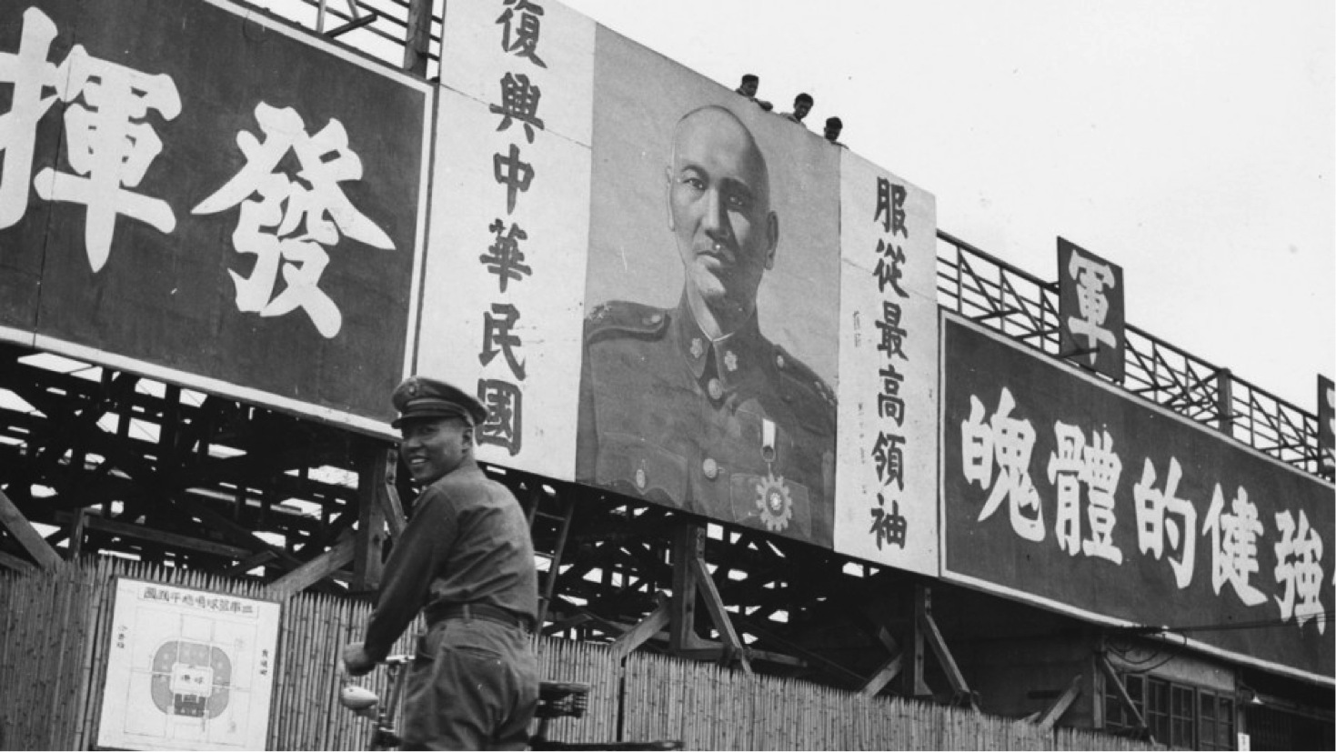 A Kuomintang soldier walks his bicycle under a picture of the Republic of China President Chiang Kai-shek. Banners hang on either side reading: "train your body" and "enlighten patriotic spirit." (FERNAND GIGON/Getty Images) 